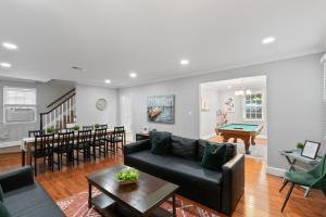 a living room with a couch and a dining room at Stately 5BR Historic Retreat - CozySuites in Alexandria