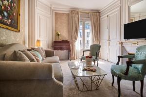a living room with a couch and a table at Hotel Westminster in Paris