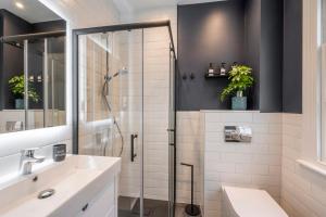 a bathroom with a shower and a sink at Pottter's Perch - Covent Garden - By Frankie Says in London