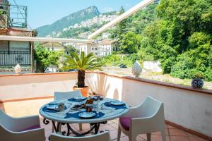 a table and chairs on a balcony with a view at River Song - Vietri sul Mare in Vietri sul Mare