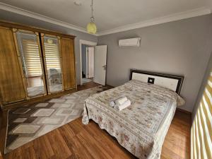 ein Schlafzimmer mit einem Bett in einem Zimmer in der Unterkunft Denize Yakın Geniş Villa in Hurmaköy + 18 Fotos