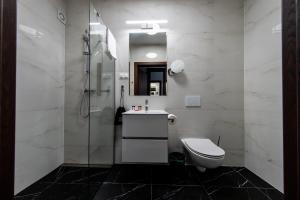 a bathroom with a toilet and a shower at Sleep&Fly Okęcie Warsaw Airport in Warsaw +27 photos