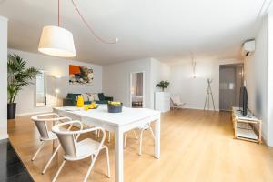a living room with a white table and chairs at Dream On - Clérigos Lofts in Porto +12 photos