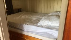 an unmade bed in a corner of a room at Chalet et Bulle La tête dans les étoiles in Audelange
