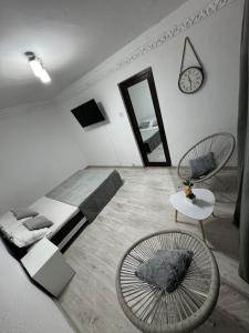 a bedroom with a bed and a mirror and a table at Oly Apartment in Năvodari