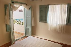 a bedroom with a bed and a window with a view at Beautiful home with private pool in Vélez de Benaudalla +17 photos