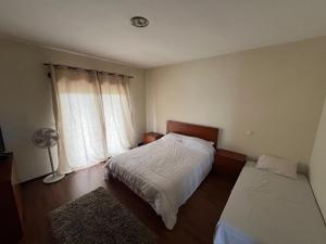 Ένα ή περισσότερα κρεβάτια σε δωμάτιο στο Casa Rosa 03