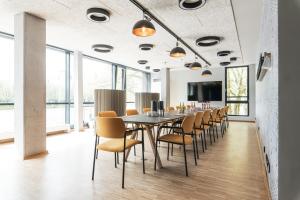 a dining room with a long table and chairs at Jugendherberge Bremen in Bremen