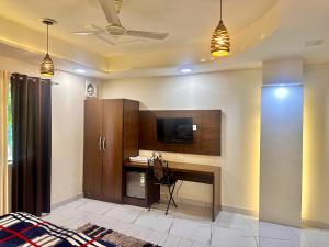 a living room with a desk and a tv at Taj Castle A Boutique Homestay in Agra