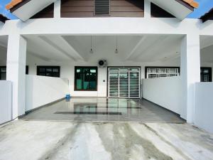 an empty garage with white walls and a glass floor at Alyn Home Muar in Muar