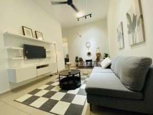 a living room with a couch and a tv at Alyn Home Muar in Muar