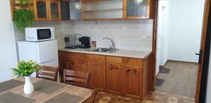 a kitchen with a sink and a microwave at Къща за гости Кралимаркови Guest house Kralimarkovi in Devin +17 photos