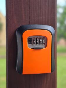 an orange object is attached to a wooden post at A&M studio apartman in Otočac