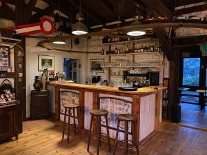 a bar with stools in a room with wooden floors at St Moritz 2 Quadenschönfeld in Möllenbeck