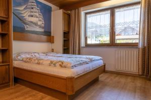 un dormitorio con una cama y una ventana en Appartements Hofer, en San Giacomo 10 fotos más