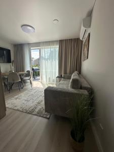 een woonkamer met een bank en een eetkamer bij Monci Resort in Palanga