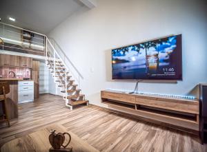 a living room with a large flat screen tv on the wall at Loft Lux Living - 7 minutes from Volos Center in Volos