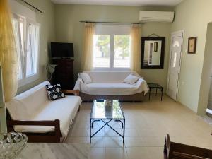 a living room with two beds and a couch at Villa Thea in Xanthi