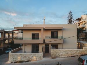 a large white building with a balcony at Dreta Suites in Chania Town