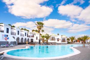 a swimming pool in front of a building at Elite Fuerteventura by Ecr in Caleta De Fuste