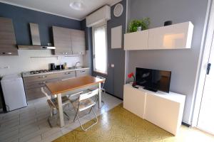 a small kitchen with a table and a television at Levante Apartment by PortofinoVacanze in Rapallo +20 photos