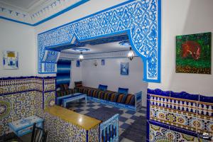 a room with blue and white tiles on the walls at Casa Voyager 'secret garden terrace' in Chefchaouen