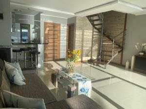 a living room with a vase of flowers on a table at Jarski Domek in Stężyca
