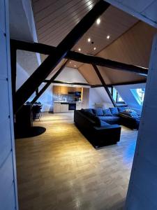a living room with a couch and a kitchen at Fewo in Zell-Merl in Zell an der Mosel +13 photos