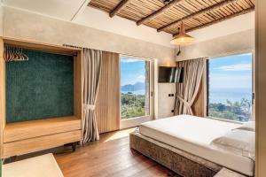 a bedroom with a bed and a large window at Casale La Torre Luxury by Feeling Italy in Massa Lubrense +126 photos