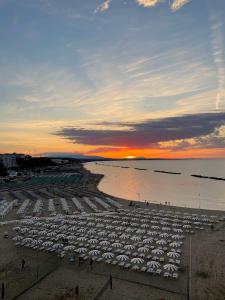 a beach with chairs and umbrellas at sunset at Barbarossa Sea Room in Termoli +24 photos