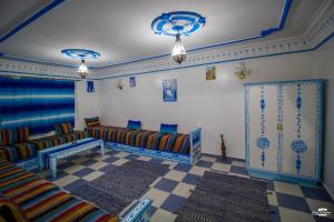 a living room with couches and a checkered floor at Casa Voyager 'secret garden terrace' in Chefchaouen