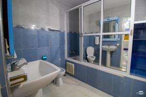 a bathroom with a tub and a sink and a toilet at Casa Voyager 'secret garden terrace' in Chefchaouen