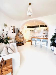 a living room with a white couch and a table at Casa Maddy in Capri +28 photos