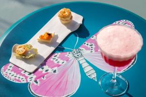 a blue plate with a drink and some desserts at IL Tornabuoni The Unbound Collection by Hyatt in Florence