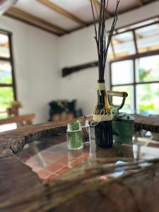 a vase with flowers in it on a table at Villa carmelita in Jardin +25 photos