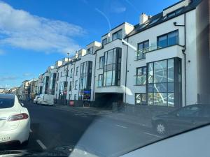 a view from a car of a street with buildings at Ocean Breeze Apartment in Portrush