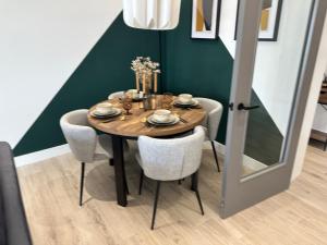 a dining room table with chairs and a dining at Ocean Breeze Apartment in Portrush +19 photos