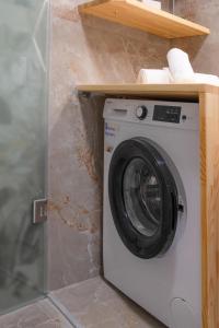 a washing machine in a bathroom with a counter at Mylos Home in Analipsi