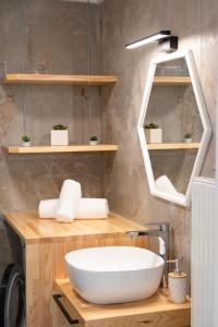 a bathroom with a white sink and a mirror at Mylos Home in Analipsi