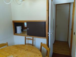 a room with a table and a tv in a room at Valmorel in Valmorel