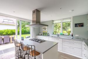 a kitchen with a stove and a counter top at Hoogelandt 106F in De Koog +24 photos