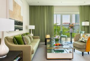 a living room with a couch and a table at Rocco Forte The Charles Hotel in Munich