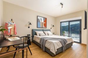 a bedroom with a bed and a desk and a window at Villa Horto in Livade +40 photos