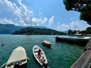 dos barcos en el agua junto a un muelle en Una mansarda sul Lago di Como, en Como