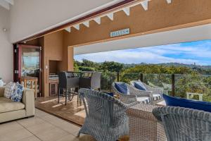 a living room with chairs and a balcony at San Lameer Villa - 14306 - 5 Bedroom Luxury - 10 pax - San Lameer Rental Agency in Southbroom