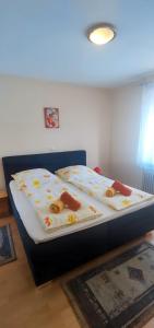 a bed in a room with two pillows on it at Alb Rooms, Zimmer auf der Schwäbischen Alb in Oberlenningen