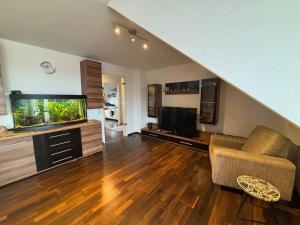 a living room with a couch and a fish tank at Fewo Thermenhafen Erding in Erding