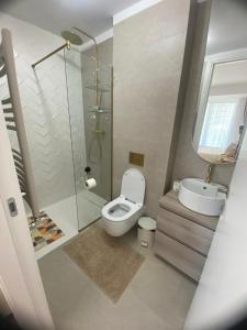 a bathroom with a toilet and a shower and a sink at Apartament Alex S 405 Vogh Olimp in Olimp +13 photos