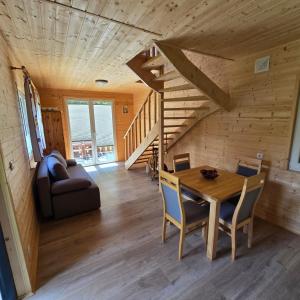 a dining room and living room with a wooden ceiling at Borówkowa Agroturystyka Nad Morzem in Darłowo +61 photos