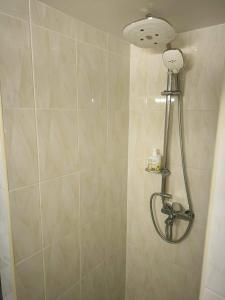 a shower with a shower head in a bathroom at Elpo House in Neveronys
